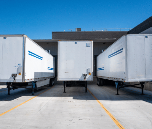 Three box trailers parked in a loading zone